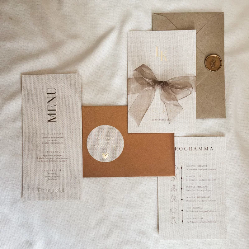 Minimalistische trouwhuisstijl in zandkleur met koperkleurige envelop